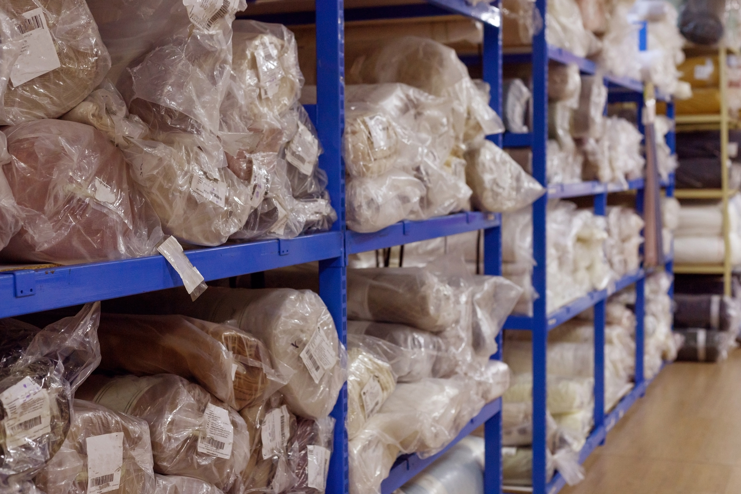 Interior of a industrial warehouse with fabric rolls.