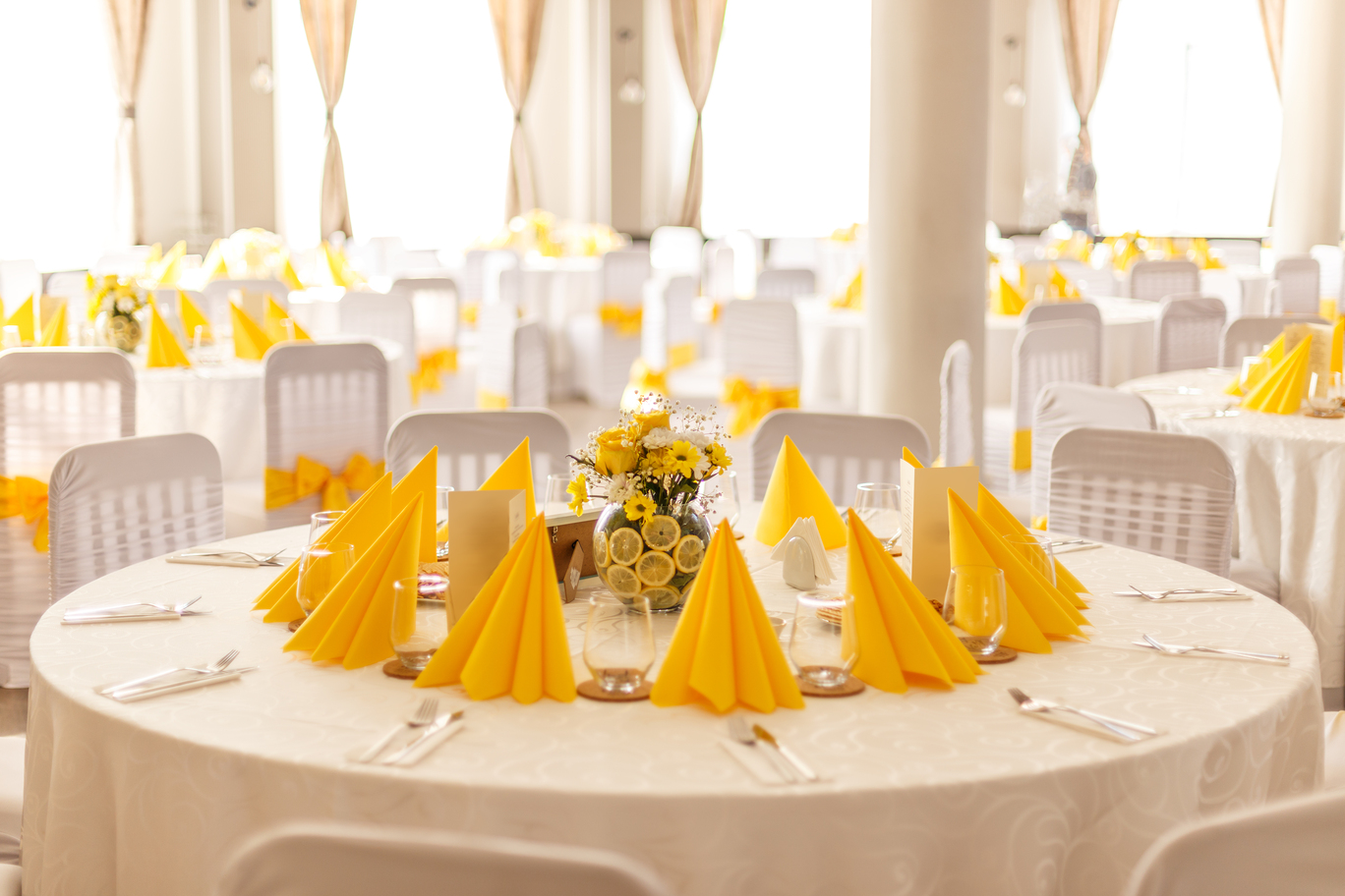 Wedding table settings with yellow napkins